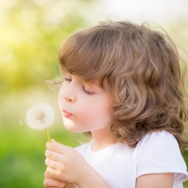 child with dandelion